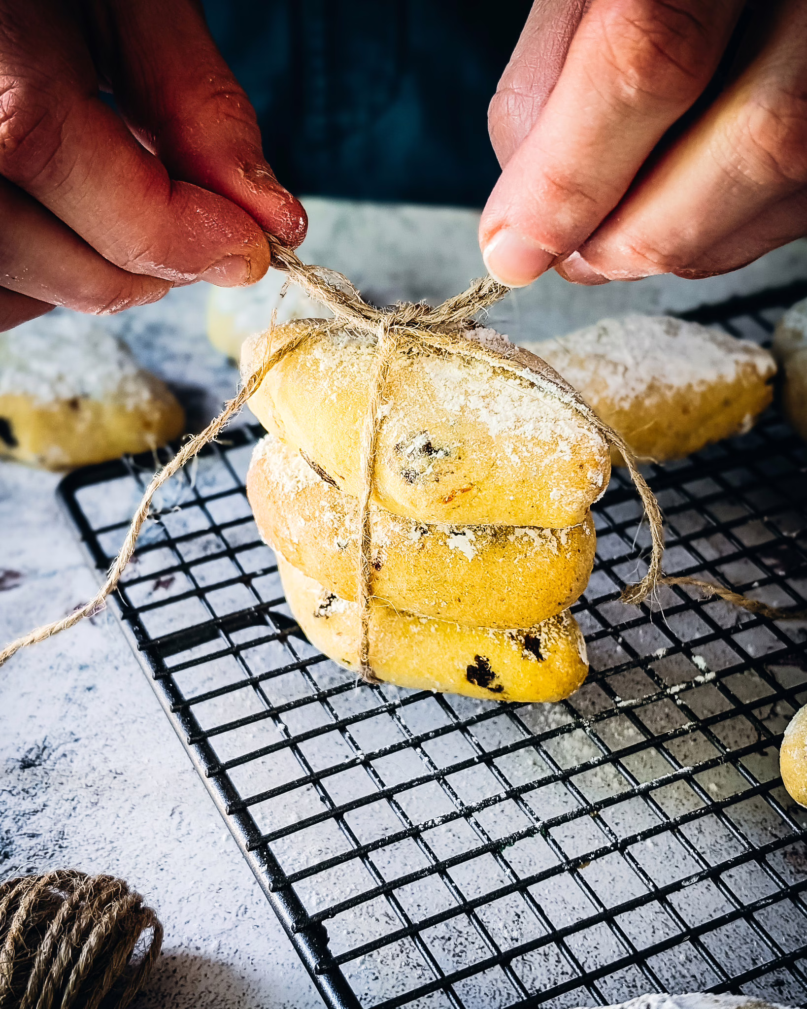Person wrapping three zaeti in wire