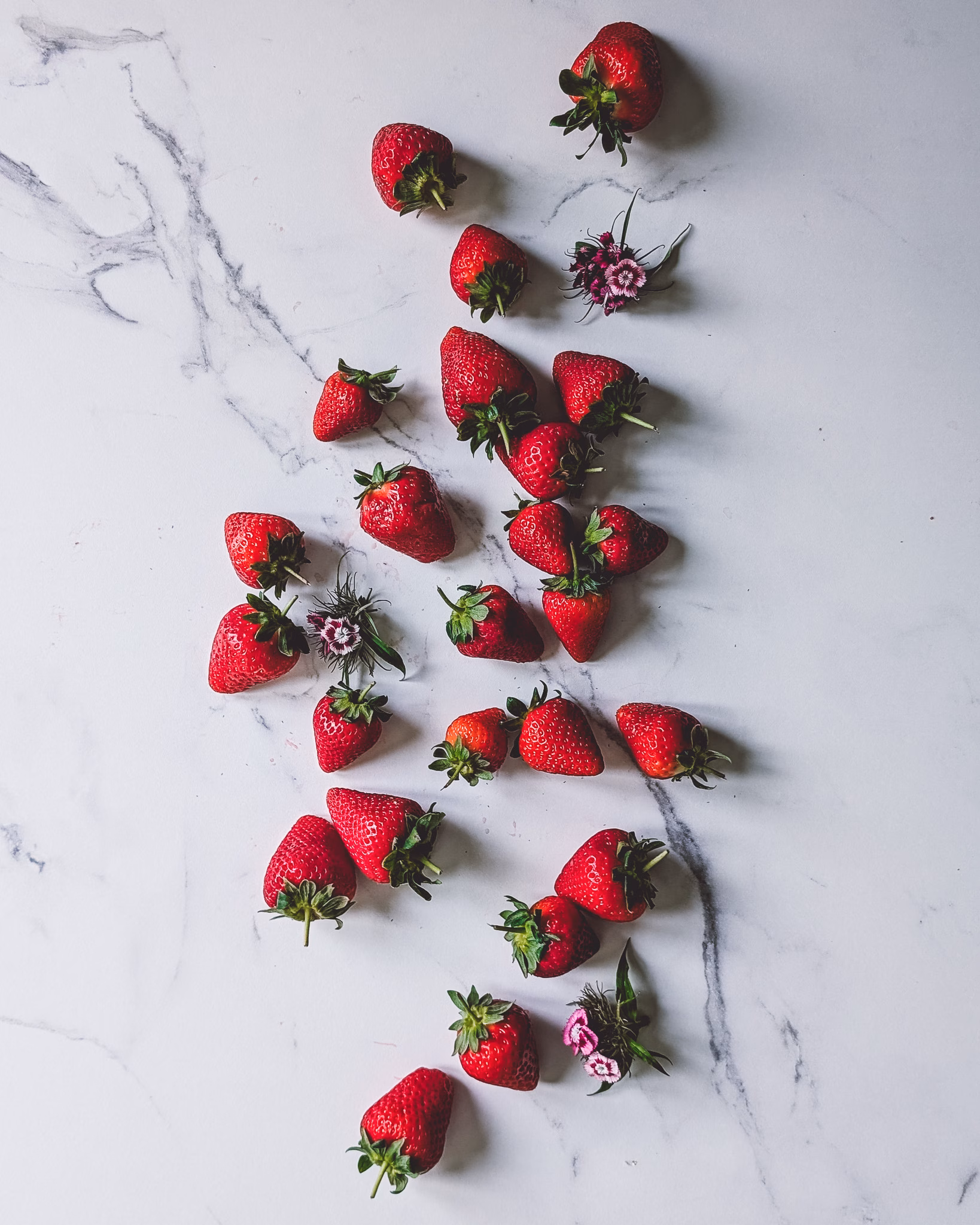 Bunch of fresh strawberries on marble table