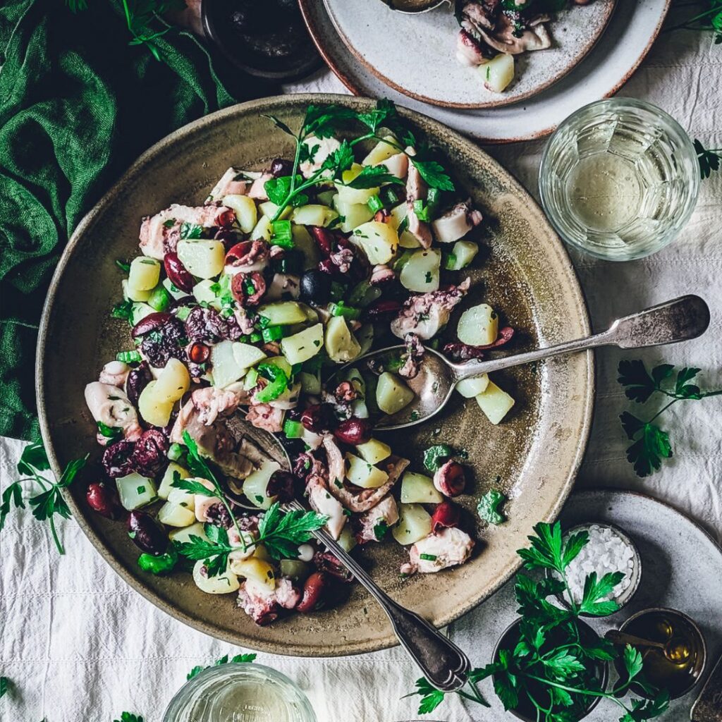 Octopus and potato salad plate with herbs