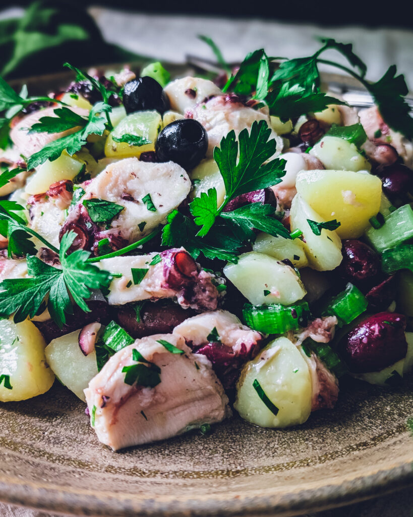 Octopus and potato salad on a serving plate
