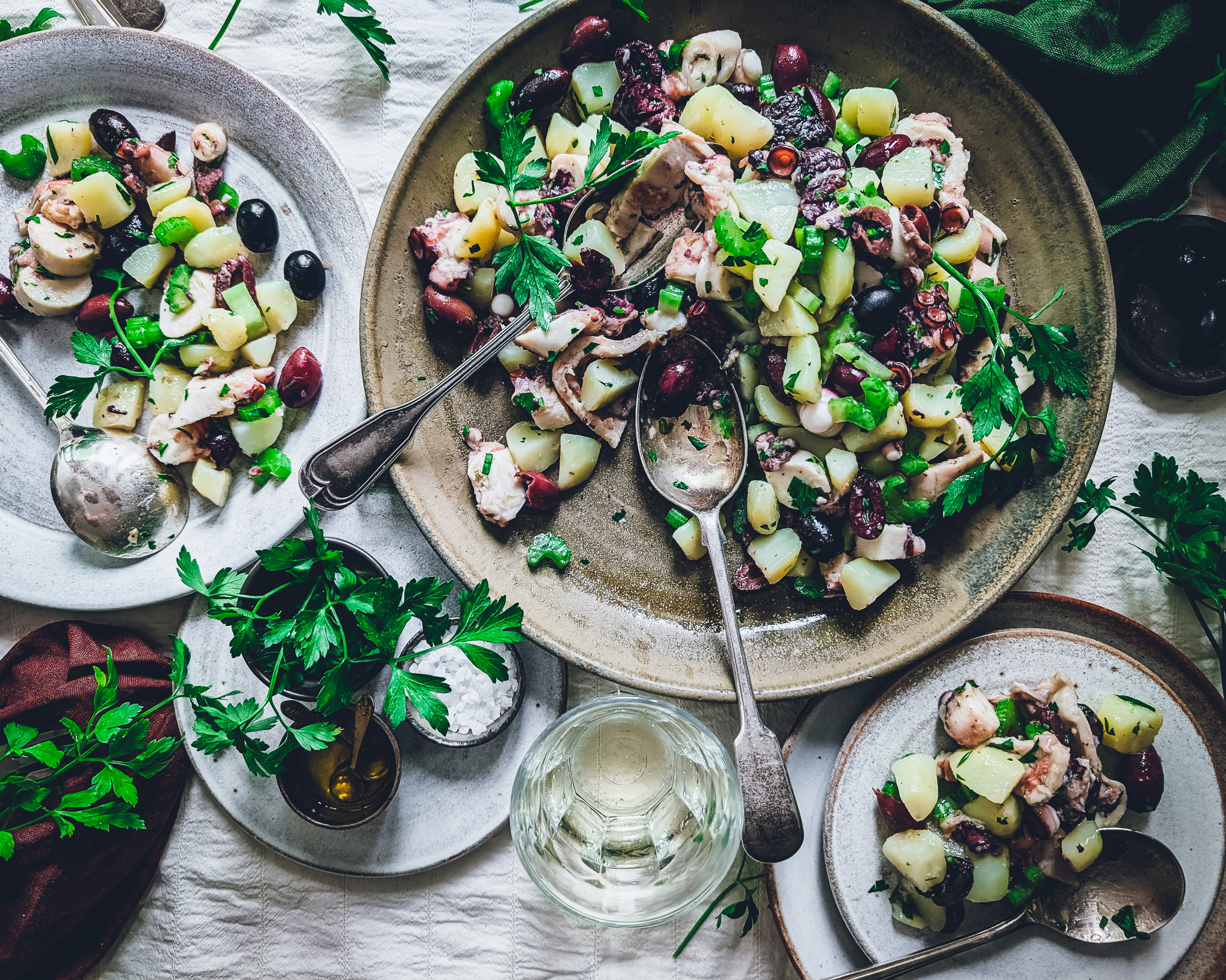 Colourful octopus and potato salad plates and bowls on a table