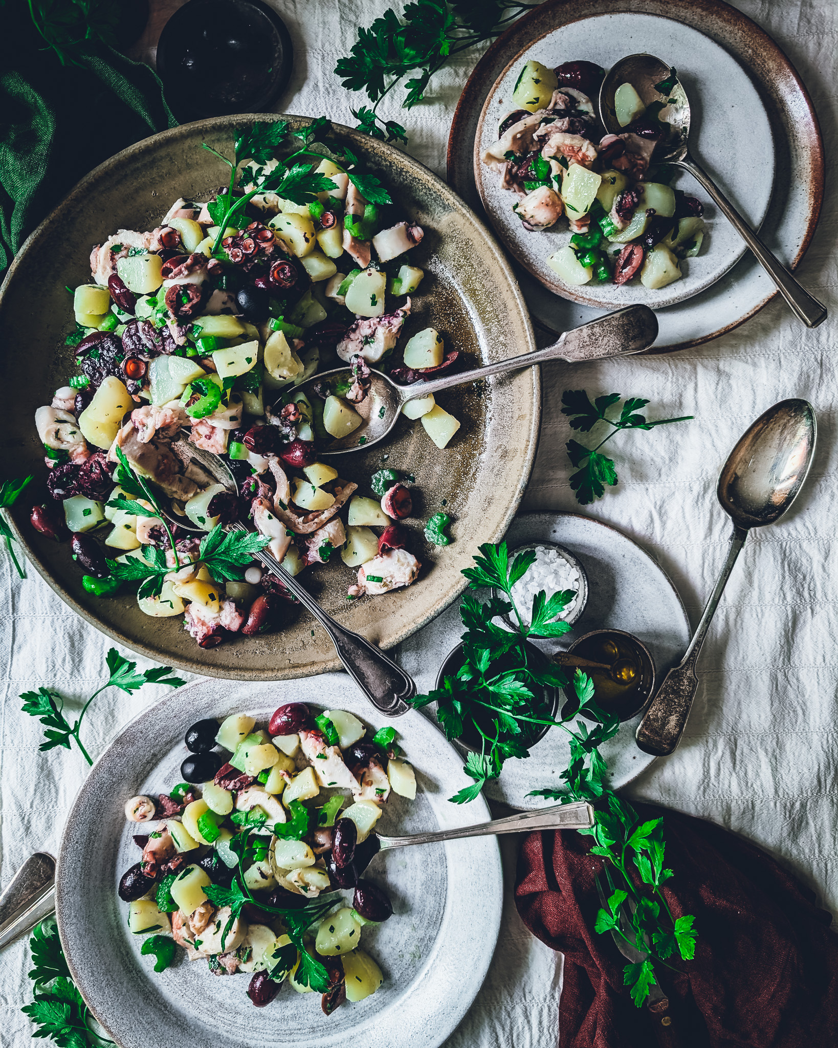 Colourful octopus and potato salad plates and bowls on a table