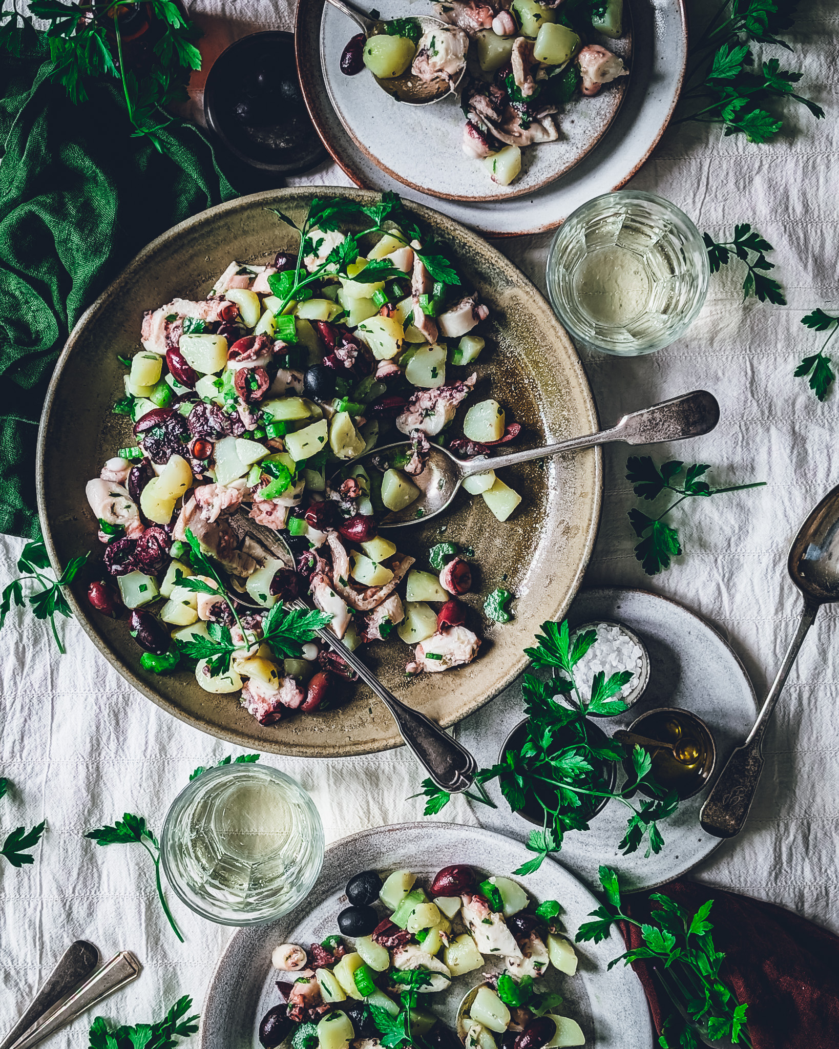 Colourful octopus and potato salad plates and bowls on a table