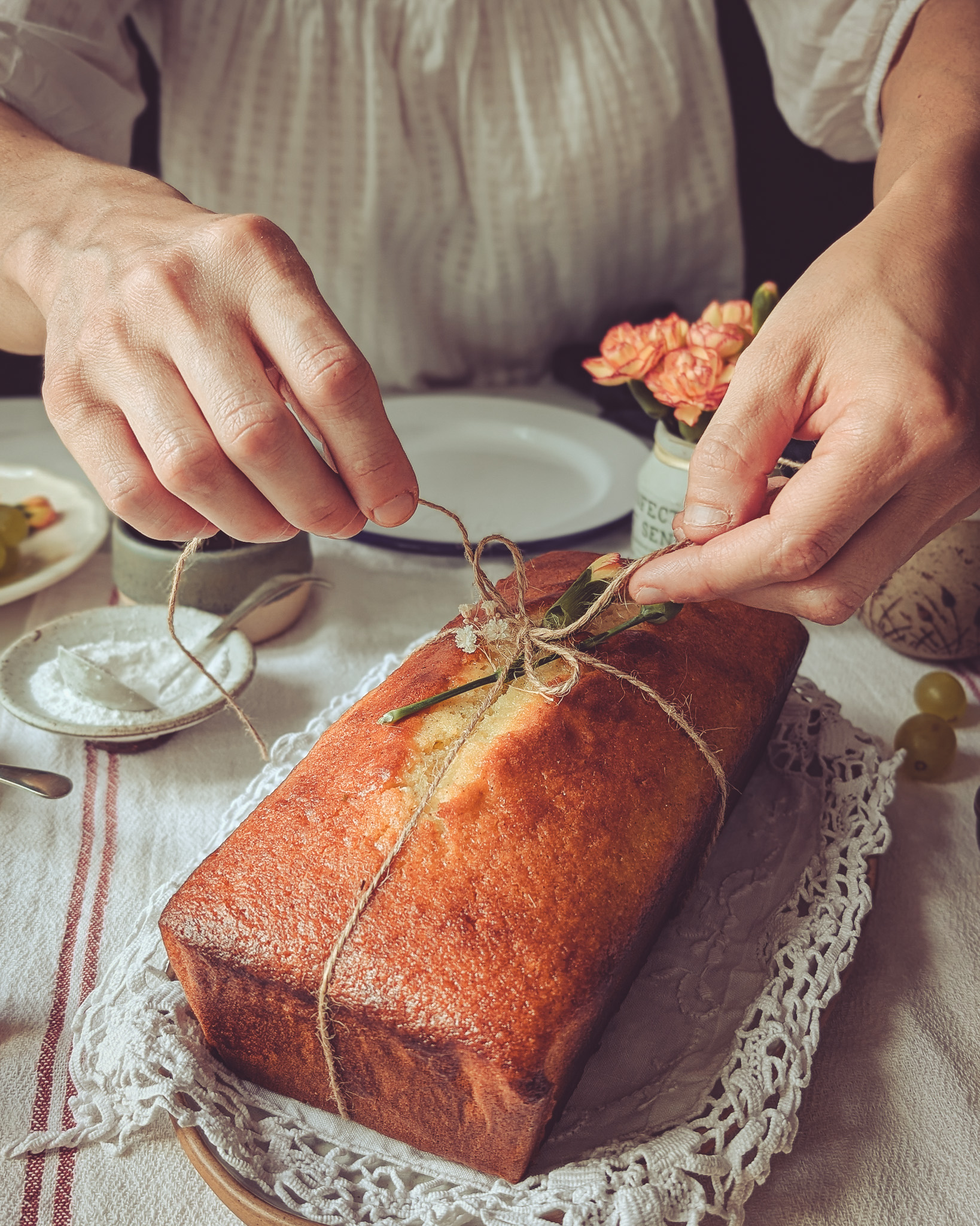 Person unwrapping cake a table.