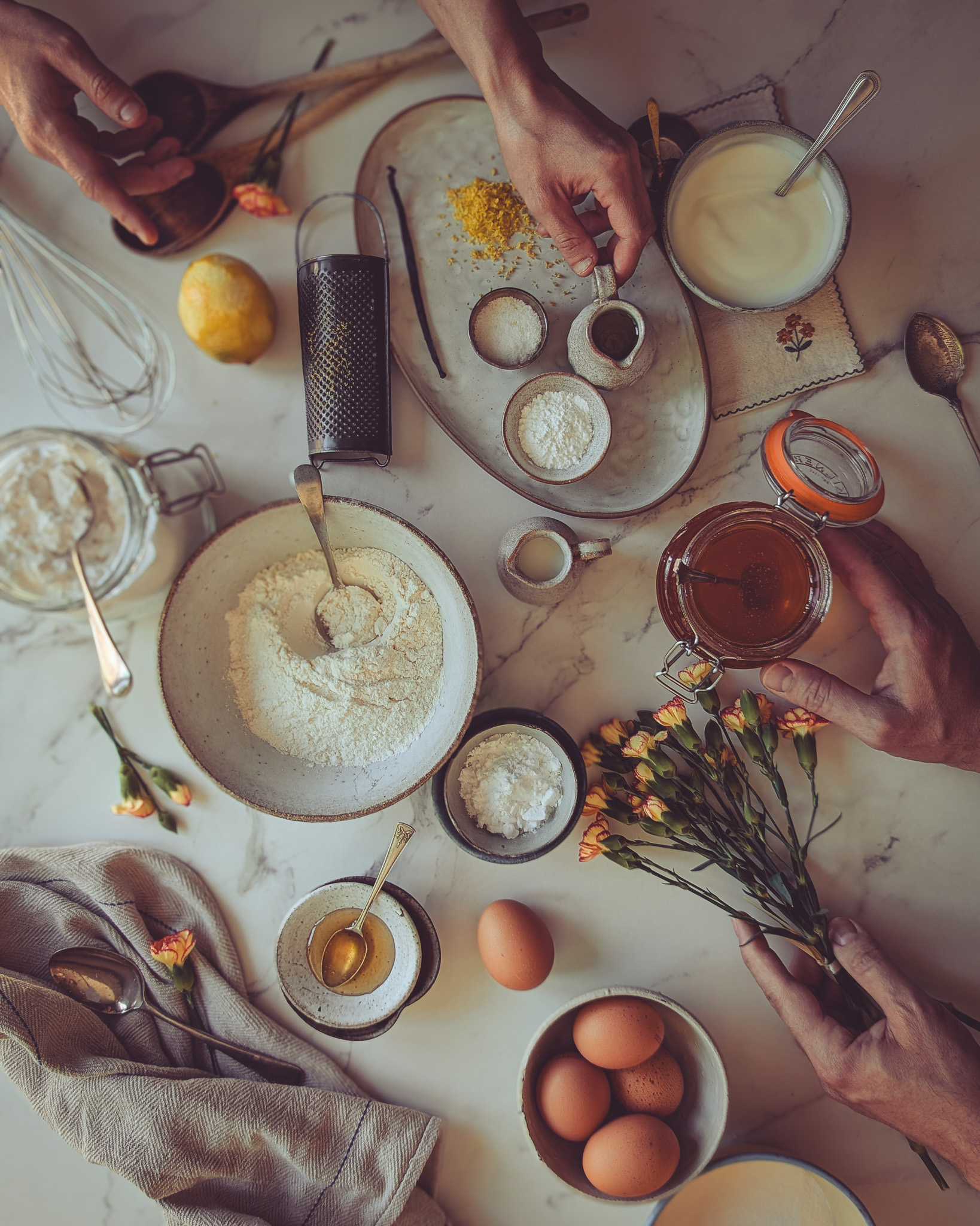 Ingredients for yoghurt and rose loaf cake (Italian plumcake) on a table.