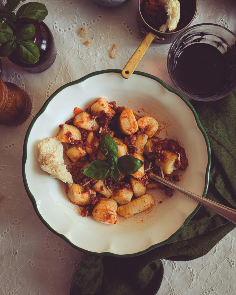 Close up of a plate full of gnocchi al ragu