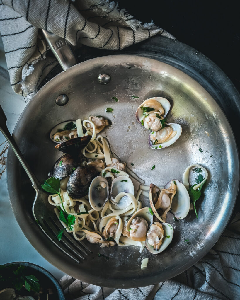 Pan half filled with linguine alle vongole.