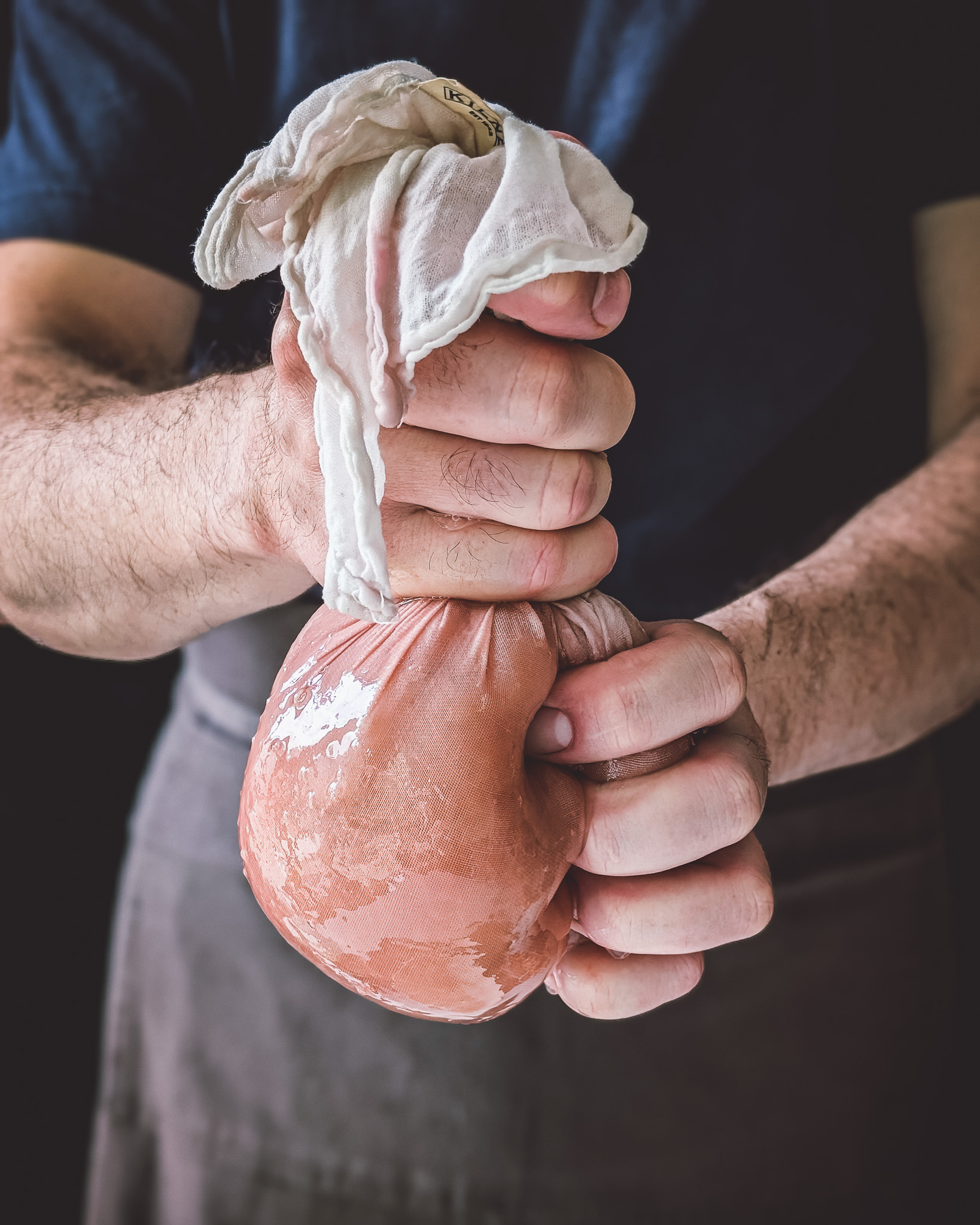 Hands of man squeezing juice of apple puree