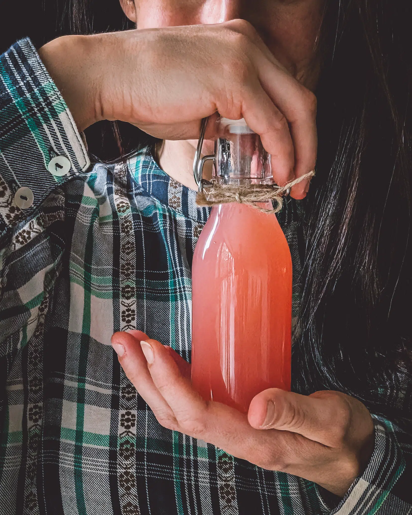 Woman holding bottle of apple juice